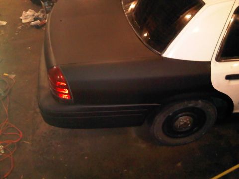 2003 Ford Crown Victoria - Rear view of a 2003 Ford Crown Victoria police car, showing the taillight and rear quarter panel.