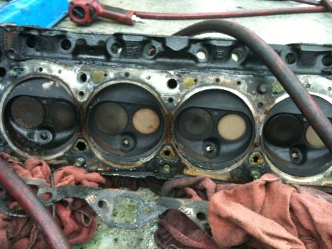 1990 Ford Bronco - Close-up of an engine cylinder head, likely removed for repair or inspection.