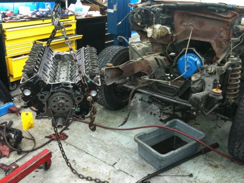 1990 Ford Bronco - Engine removal in progress, with the vehicle chassis partially visible in the background.