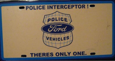 2000 Mercury Grand Marquis - License plate reads "POLICE INTERCEPTOR!" and "THERES ONLY ONE" with a Ford logo.
