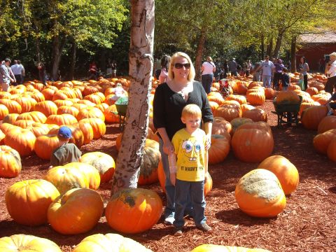 1979 Ford F-150 - A woman and a young boy pose for a photo amidst a large display of pumpkins at an outdoor fall festival.