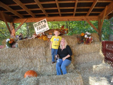 1979 Ford F-150 - A woman and a young boy pose for a photo on a display of hay bales at Burt's Farm.