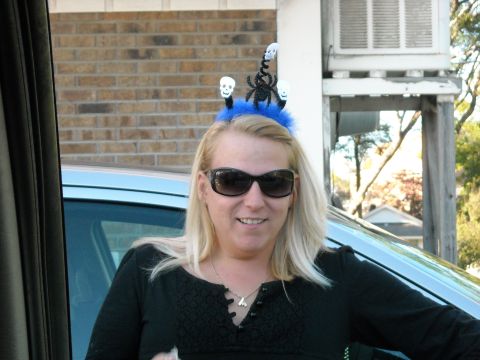 1979 Ford F-150 - A woman smiles while wearing a festive Halloween headband with skull decorations.