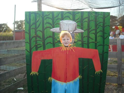 1979 Ford F-150 - A child poses for a photo in a scarecrow cutout at an outdoor event.