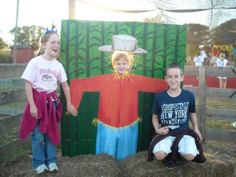 1979 Ford F-150 - Children interact with a scarecrow cutout at a fall festival.