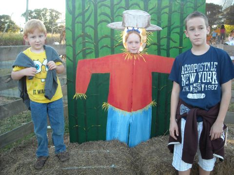 1979 Ford F-150 - Children pose with a scarecrow cutout at a fall festival.