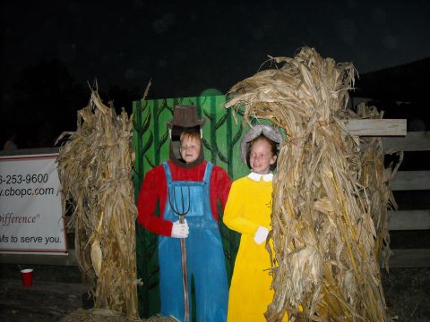 1979 Ford F-150 - A fall festival scene features cardboard cutouts of a farmer with a pitchfork and a girl in a yellow dress, surrounded by corn stalks.