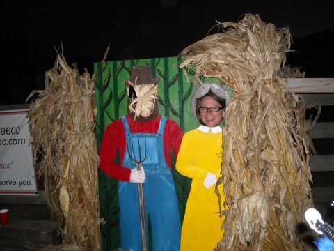 1979 Ford F-150 - Photo booth cutout figures of a farmer and a woman, decorated with corn stalks for a fall theme.