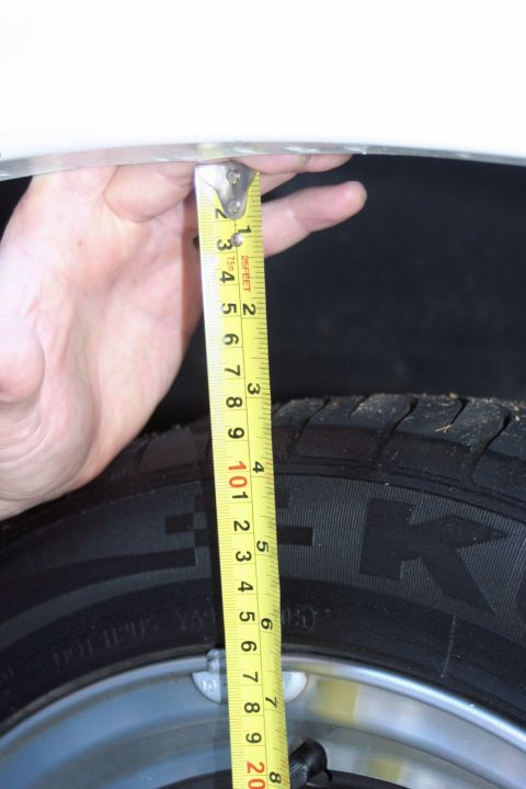 1976 Ford Ranchero - A tape measure is used to gauge the suspension height of a vehicle.