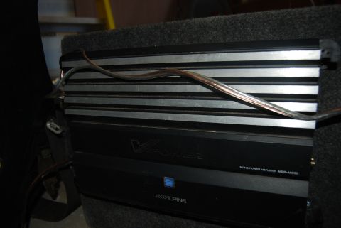 1982 Ford Bronco - Close-up of an Alpine V-Power mono power amplifier, model MBP-M350, mounted in a vehicle.