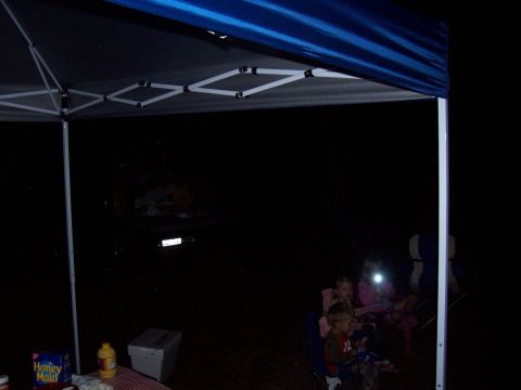 1994 Ford Bronco - A 1992 Ford Bronco is visible in the background of a campsite scene at night.
