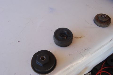 1982 Ford Bronco - Several rubber bump stops are shown, some with visible hex bolt heads, on a white surface.