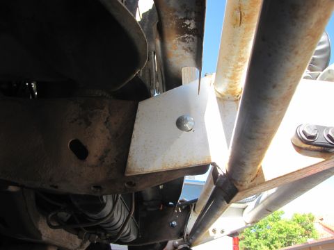 1978 Ford Bronco - Underside view of vehicle frame showing modifications and roll cage attachment points.