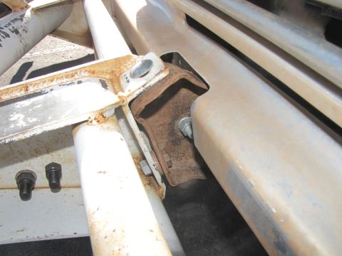1978 Ford Bronco - This image shows a close-up view of the vehicle's frame, focusing on rusty metal brackets and bolts.