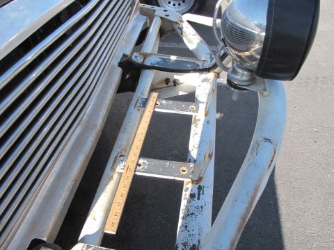 1978 Ford Bronco - Close-up of a vehicle's front grille and a custom bumper, with a ruler placed for measurement.