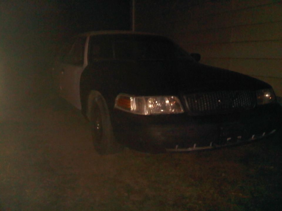 Front view of a 2003 Ford Crown Victoria with a dark grille