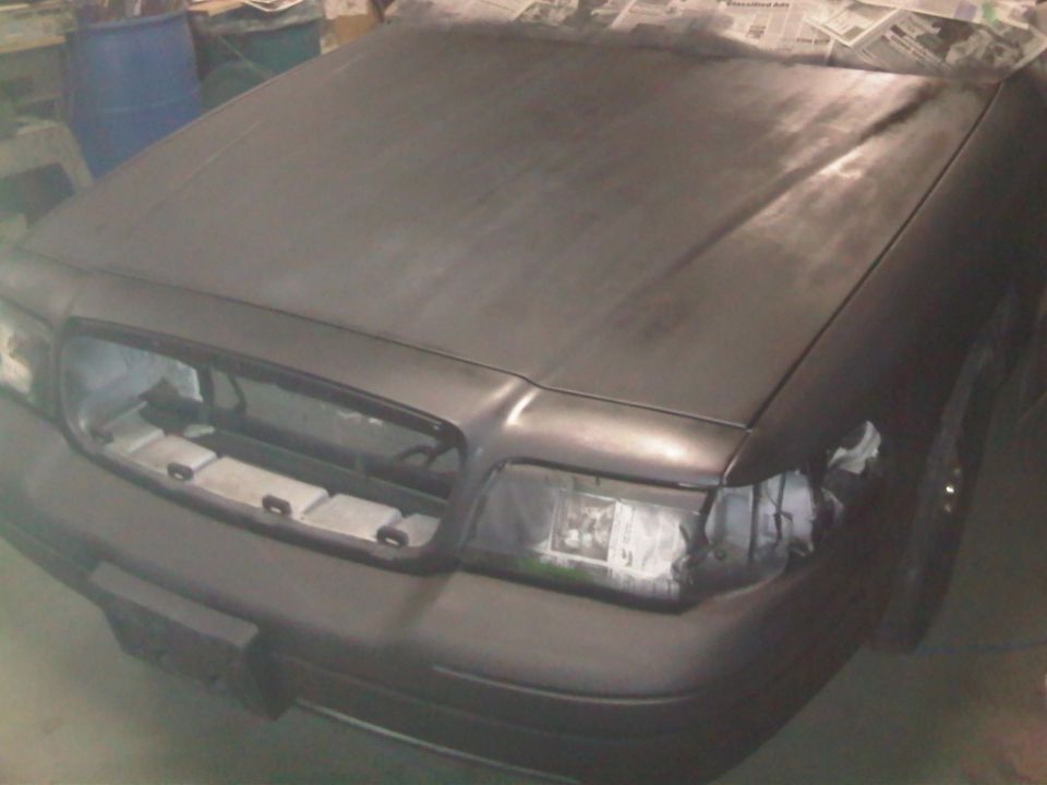 2003 Ford Crown Victoria front end, primer gray, grille removed, headlights taped