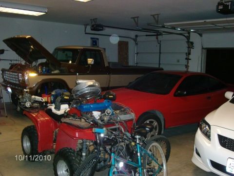 1979 Ford F-150 - Multiple vehicles and parts are stored inside a garage, with a date stamp of 10/11/2010.