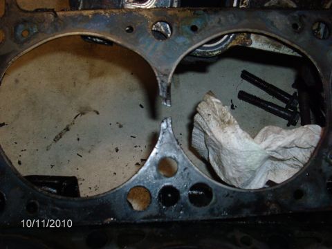 1979 Ford F-150 - Close-up of a damaged engine cylinder head gasket, showing the extent of the mechanical failure.