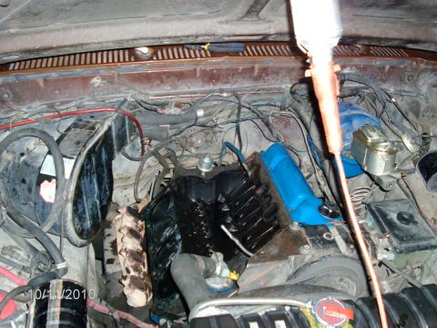 1979 Ford F-150 - Overhead view into an open engine bay with the intake manifold removed, exposing the bare V8 valley with pushrods and lifters visible and t…