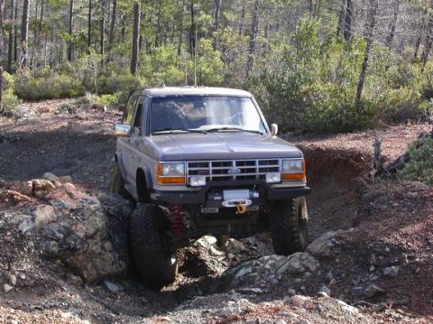 1990 Ford Bronco II - This Ford Ranger is navigating a rocky trail in a wooded area.