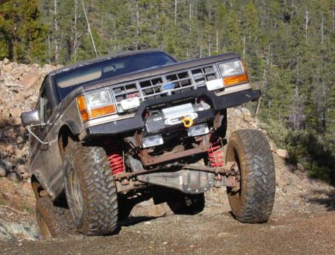 1990 Ford Bronco II - This 1990 Ford Bronco II navigates a rocky trail with its front wheel lifted.