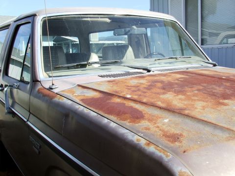 1982 Ford Bronco - The hood of this vehicle is heavily rusted, indicating it has been exposed to the elements for a long time.