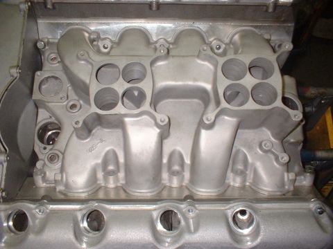 1965 Ford 427 - This is a close-up view of an engine's intake manifold, showing its complex internal structure.
