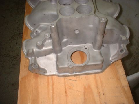 1965 Ford 427 - Aluminum intake manifold shown on a wooden surface.