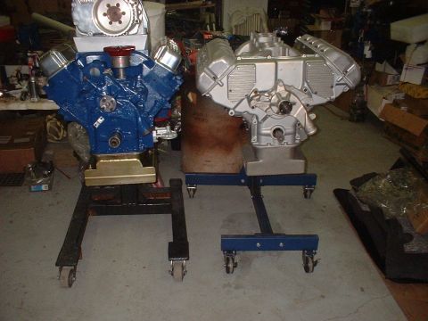 1965 Ford 427 - Two V8 engines are displayed on rolling stands in a workshop setting.
