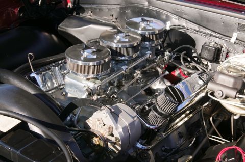 2006 Cadillac STS - Close-up view of a V8 engine a triple carburetor setup and chrome valve covers.