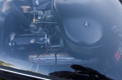 2006 Cadillac STS - Close-up view of an engine bay, an air cleaner assembly, generator, and a visible label indicating a high compression test.