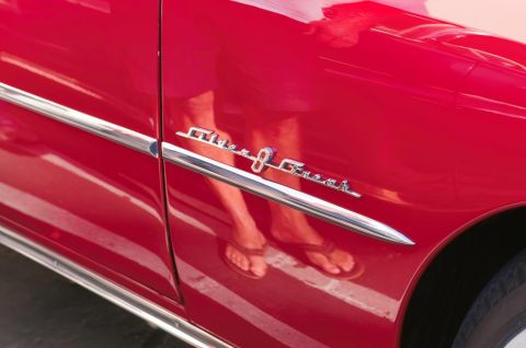 2006 Cadillac STS - A close-up of a red car's side panel reveals a "Golden Comet 8" emblem and chrome detailing.