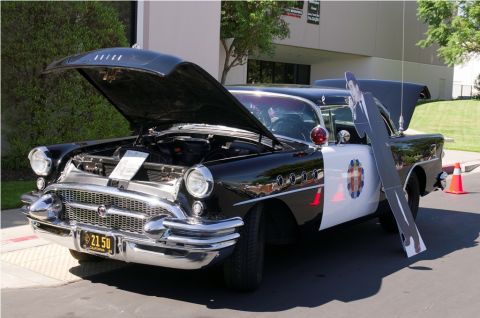 2006 Cadillac STS - This vintage police car, likely from the mid-1950s, is displayed with its hood open.