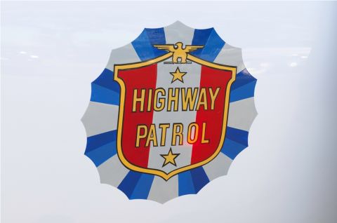 2006 Cadillac STS - A shield-shaped emblem with 'HIGHWAY PATROL' text and an eagle graphic.