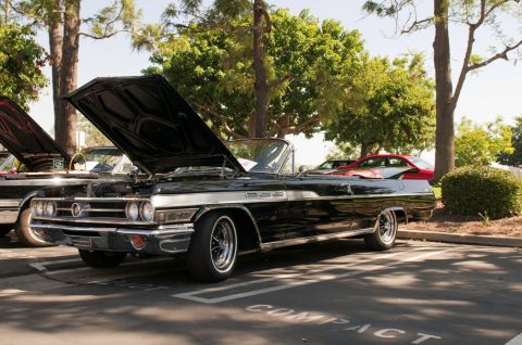 2006 Cadillac STS - Classic black convertible parked outdoors with its hood raised, showing the engine bay.