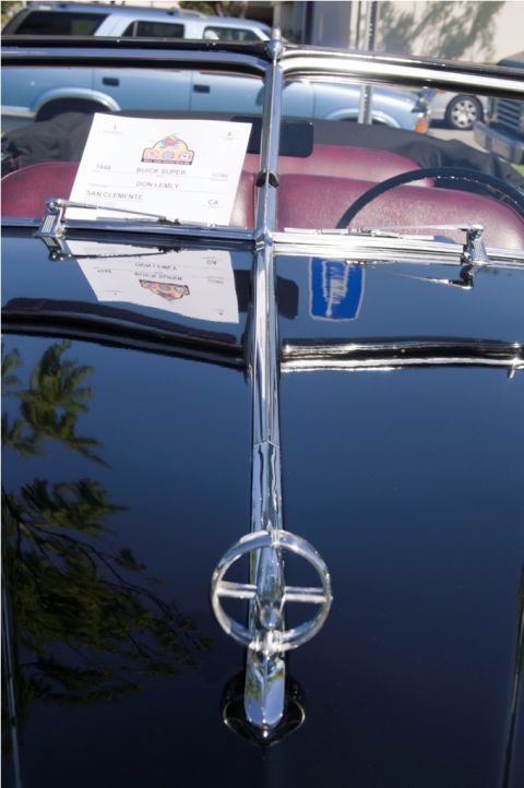 2006 Cadillac STS - A sign on the windshield of a black convertible indicates it is a 1946 Buick Super, not a 2006 Cadillac STS.