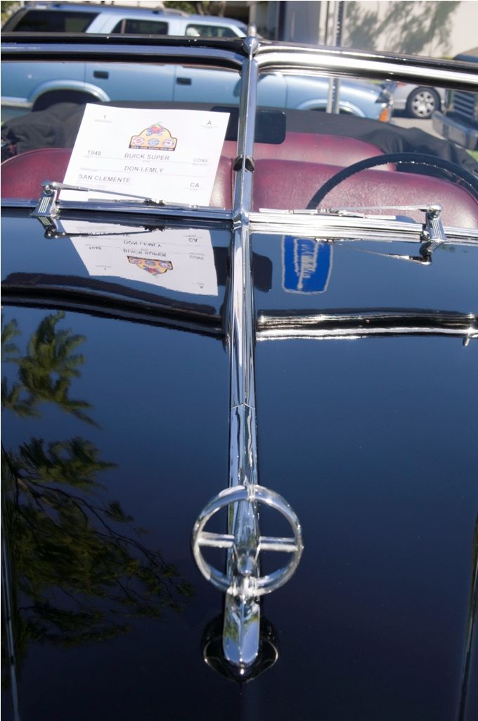 Black convertible hood ornament and windshield with 1946 Buick Super sign
