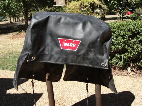1967 Ford Mustang - This is a black cover for a Warn winch, the brand's distinctive red logo.