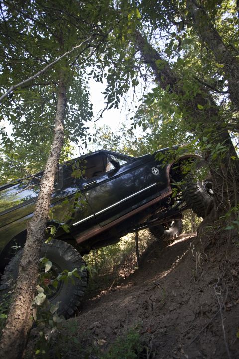 1995 Ford Bronco - This 1995 Ford Bronco is navigating a challenging off-road course on a muddy incline.