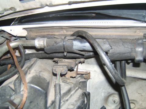 1988 Ford Bronco - Close-up view of engine bay components, showing a hose with cracked and damaged insulation.