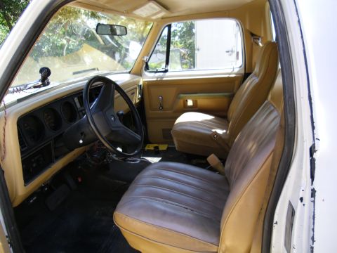 1987 Dodge 1500 - Interior view of a vintage truck, showing the dashboard, steering wheel, and seats.