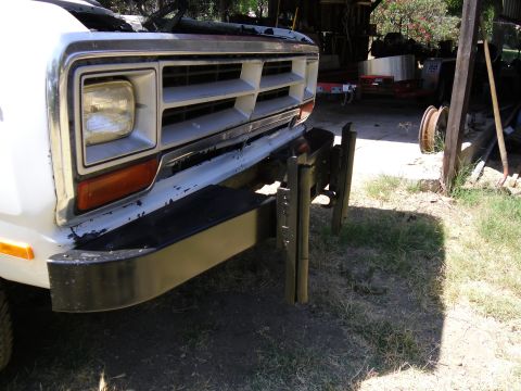 1987 Dodge 1500 - Close-up of a truck's front grille and bumper, showing wear and tear.
