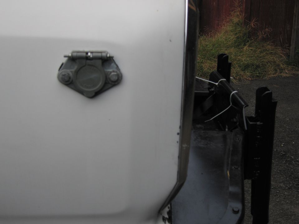 trailer hitch connector on white vehicle