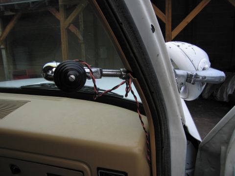 1987 Dodge 1500 - Close-up view of the interior of a vehicle, focusing on the side mirror and exposed wiring.