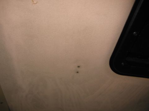1987 Dodge 1500 - Interior headliner detail showing two marks and a section of black trim.