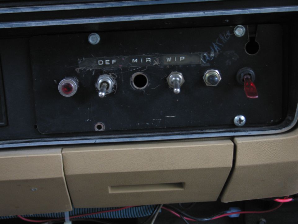 Dashboard switch panel with labels DEF, MIR, WIP, toggle switches, and a red rocker switch
