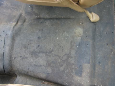 1987 Dodge 1500 - Interior view of a car's floor carpet, showing wear and tear.