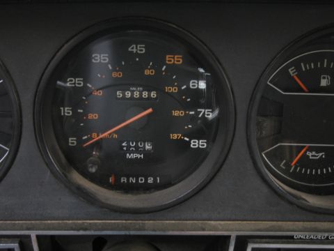 1987 Dodge 1500 - Dashboard gauges display mileage, speed, and fuel level in a vehicle interior.