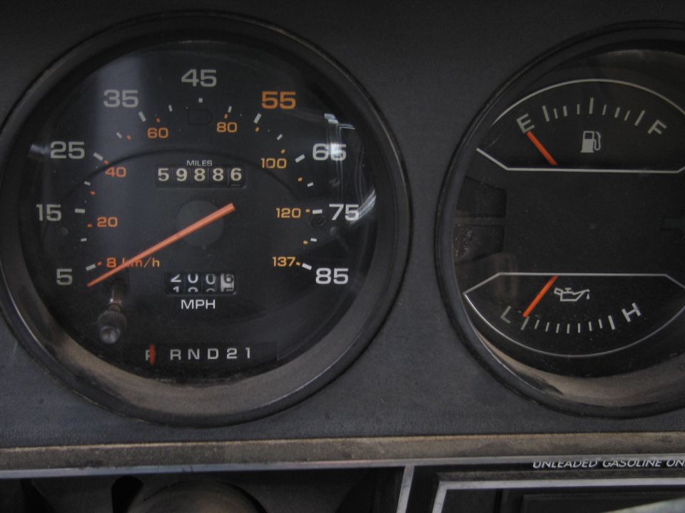Speedometer shows 59,886 miles, fuel gauge is low, oil pressure gauge is low. RND21 gear indicator is visible